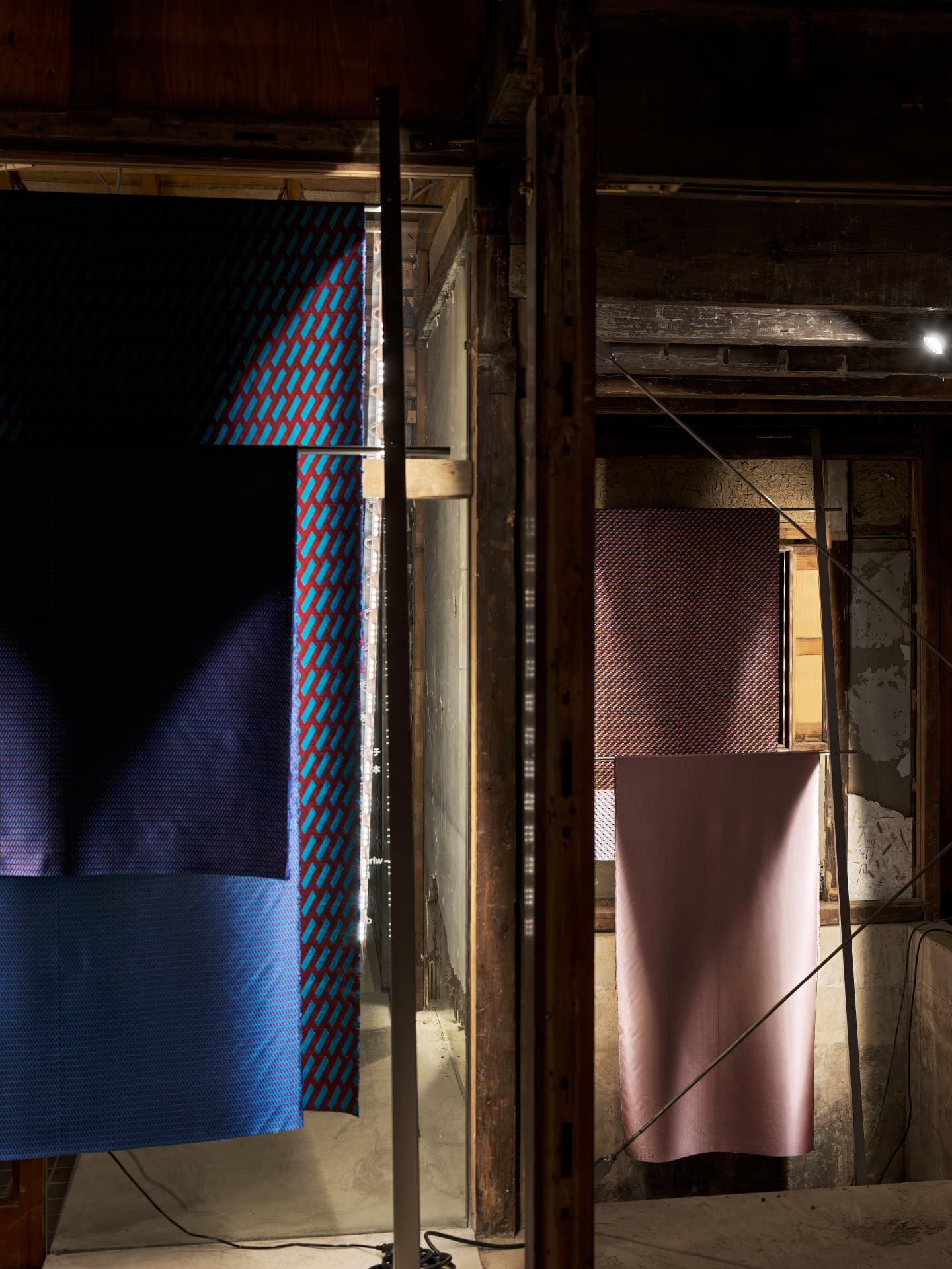 Textiles hanging in a wooden machiya interior