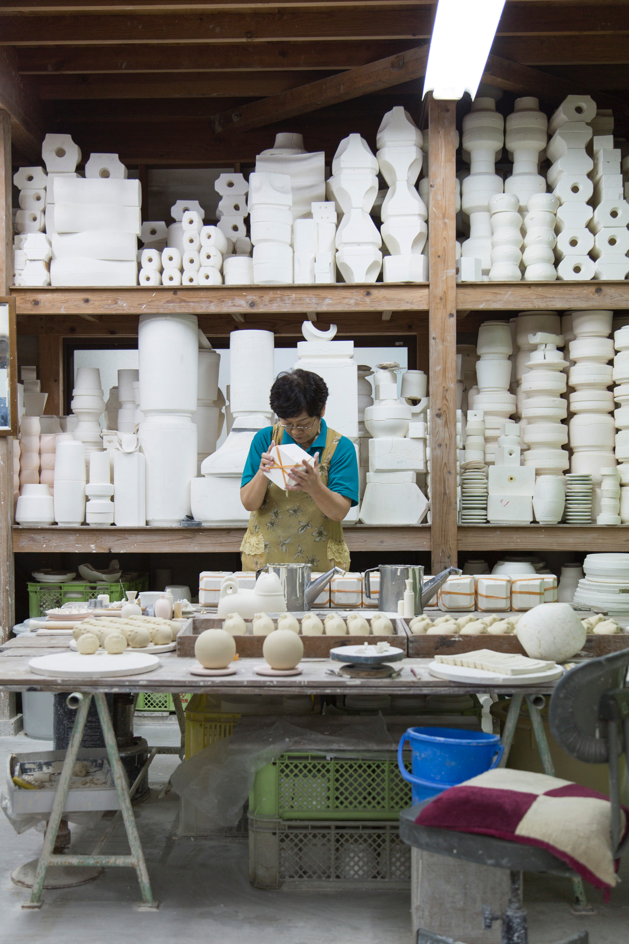 Maker shaping porcelain in a workshop